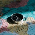 A close-up shot of a compass resting on a map of India, symbolizing exploration and travel.